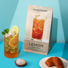 Hakumori Lemon Iced Tea Kit with a glass of iced lemon tea topped with coconut jelly, garnished with lemon slices and mint, displayed on a bright blue background with snacks.
